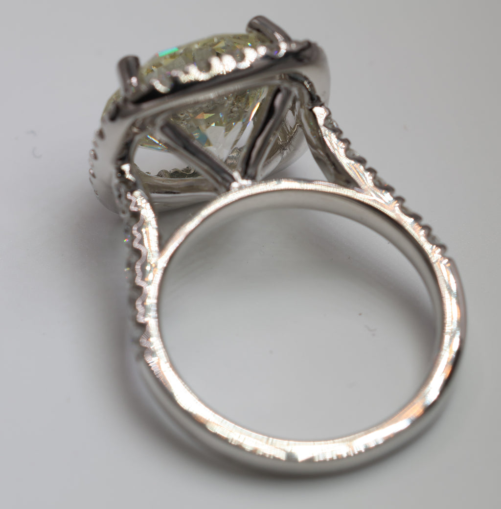 5.75 Round Brilliant Cut Diamond set in a platinum square halo setting