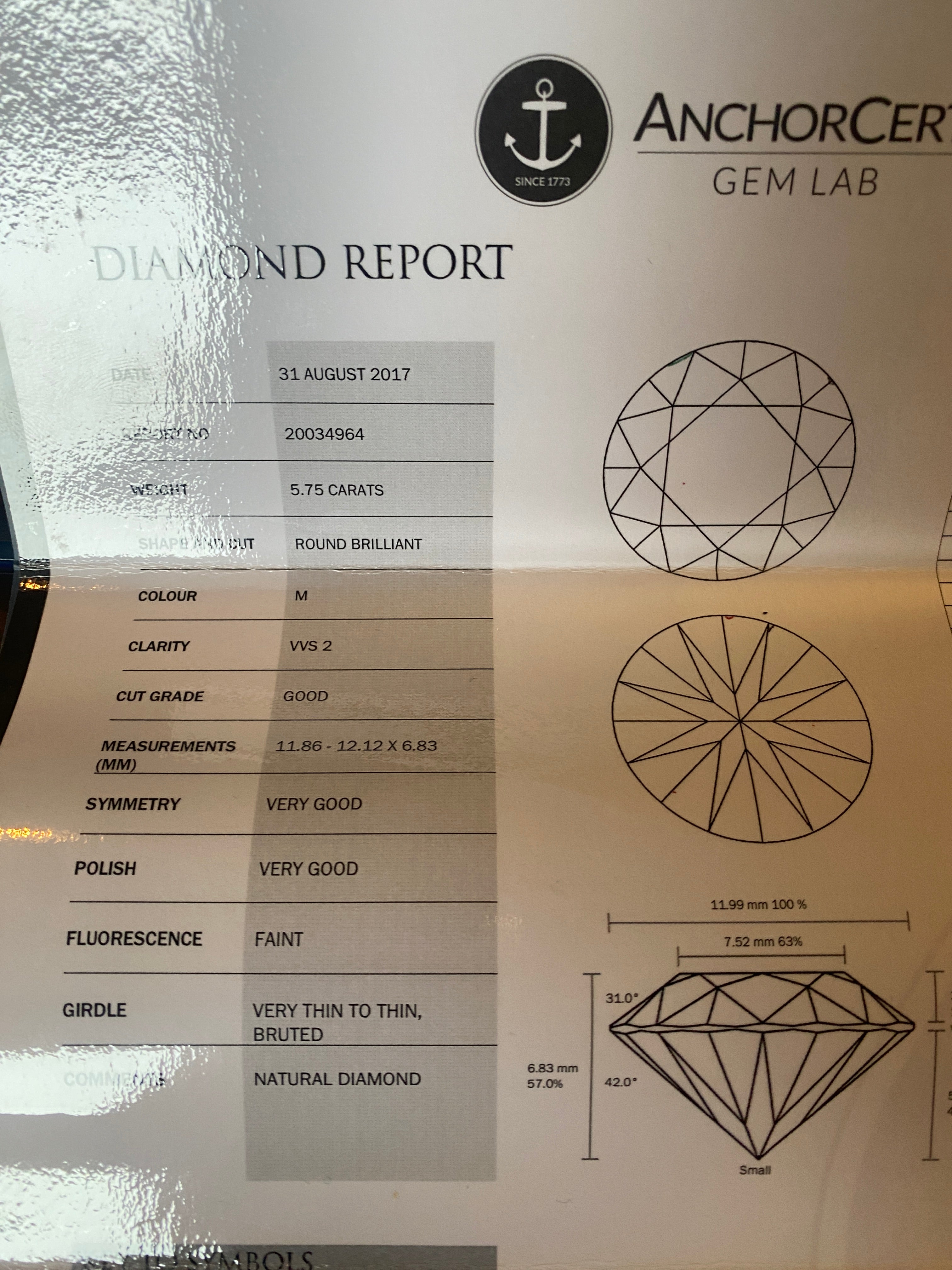 5.75 Round Brilliant Cut Diamond set in a platinum square halo setting