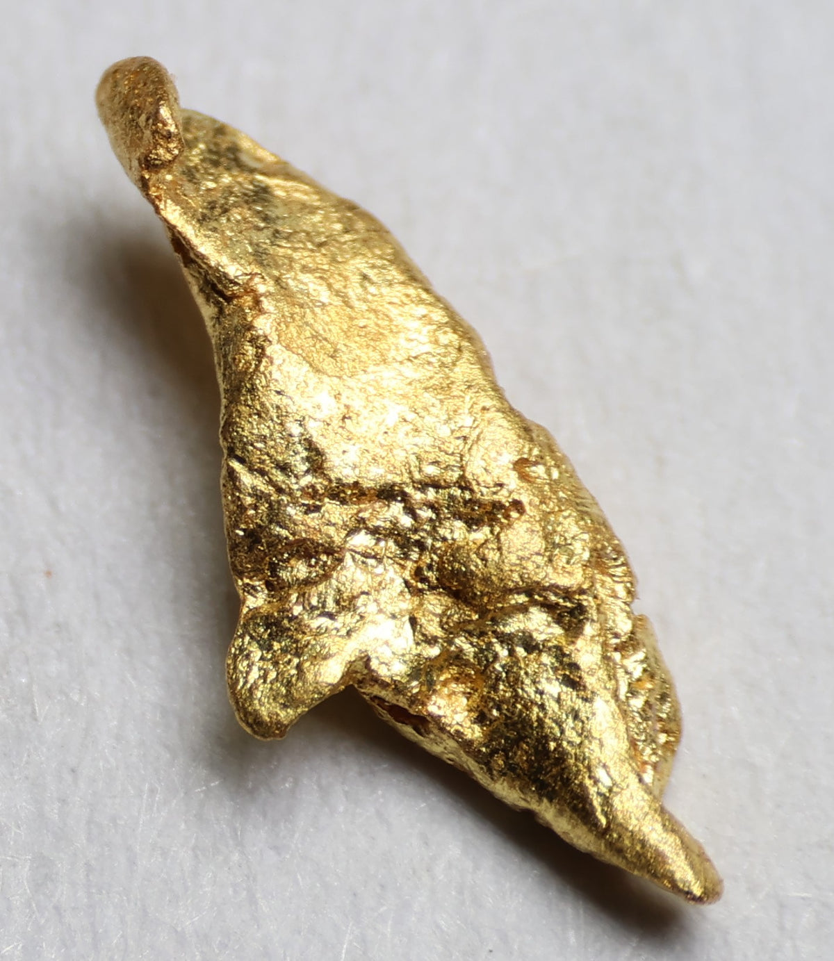Close-up detail of the natural nugget’s textured gold surface
