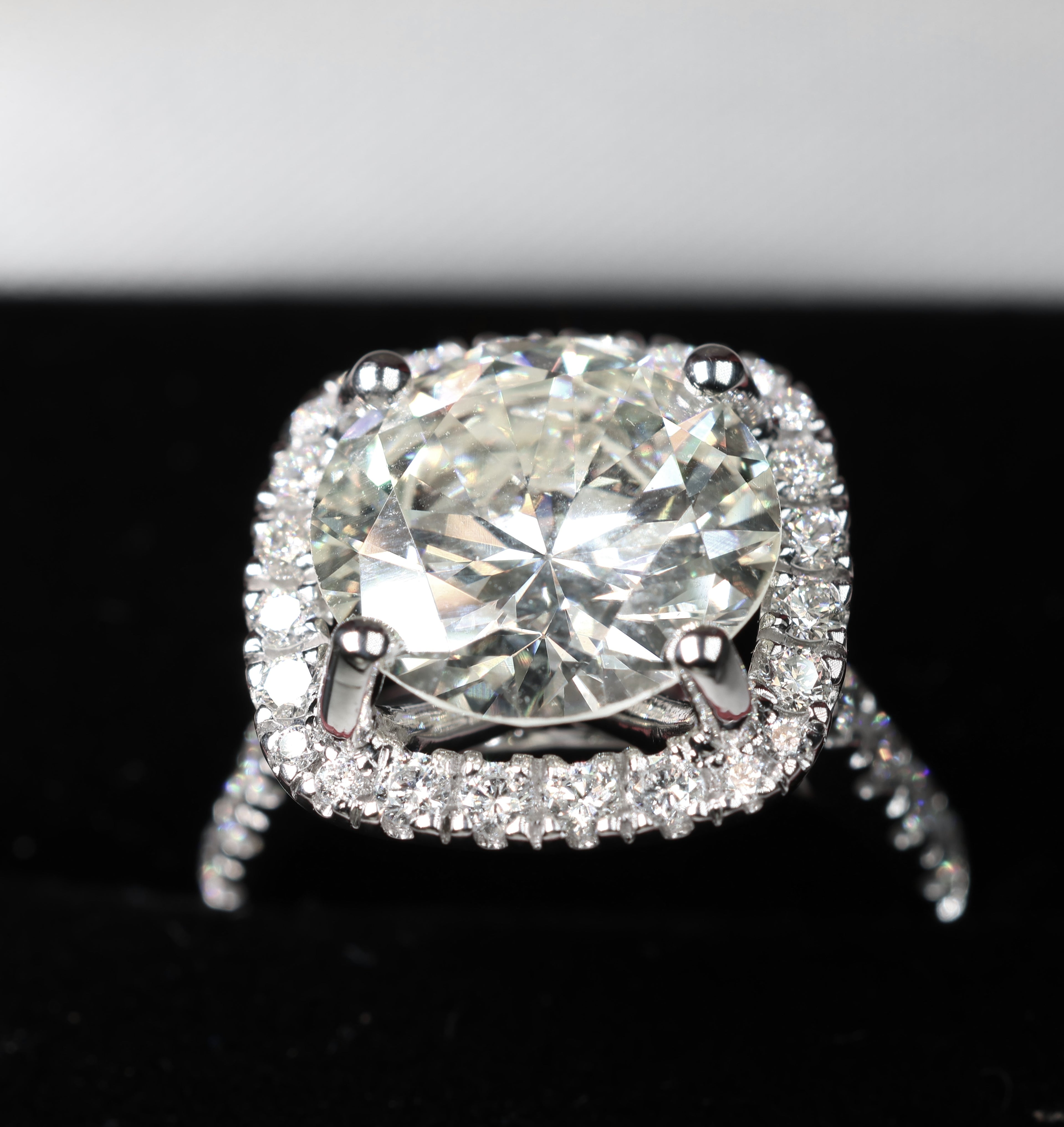 5.75 Round Brilliant Cut Diamond set in a platinum square halo setting