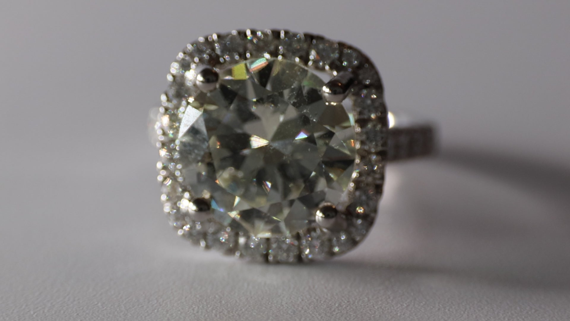 5.75 Round Brilliant Cut Diamond set in a platinum square halo setting