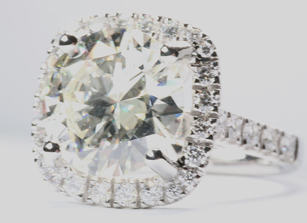 5.75 Round Brilliant Cut Diamond set in a platinum square halo setting