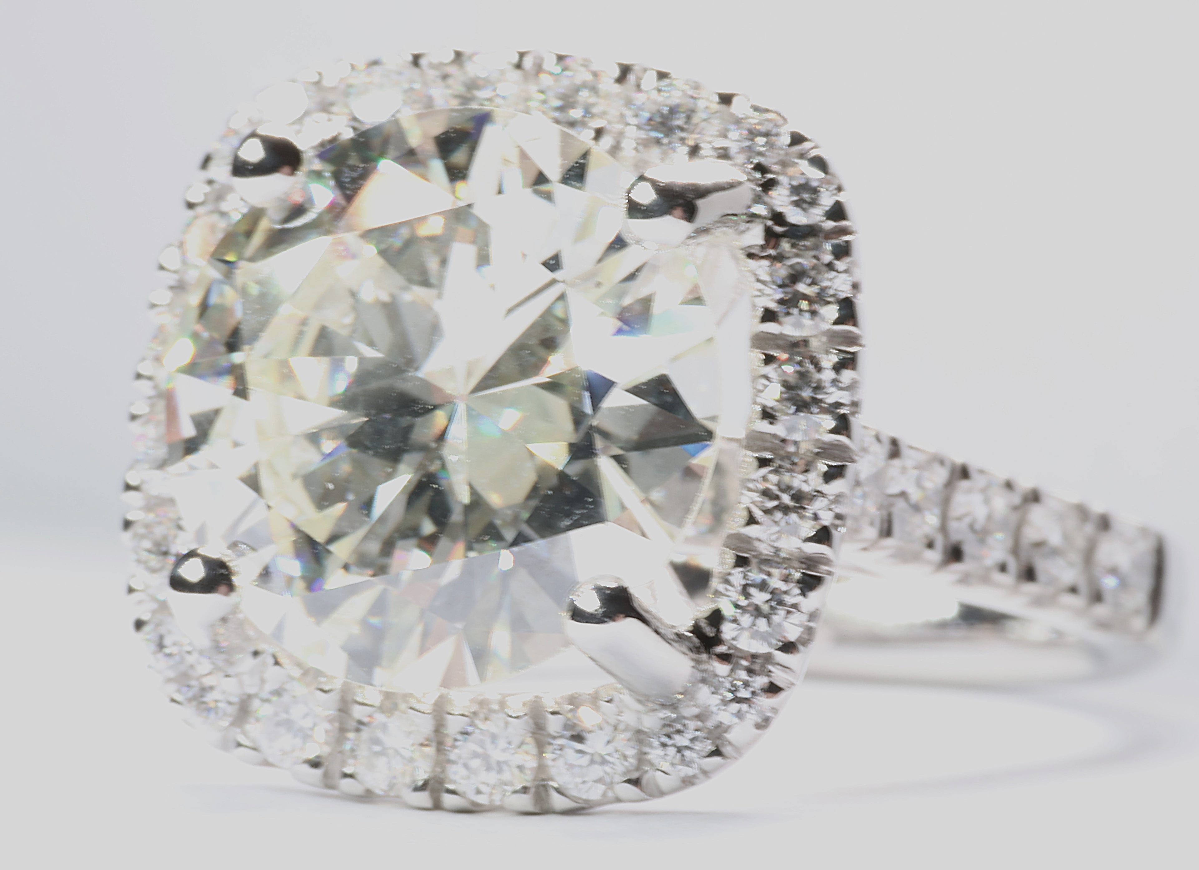 5.75 Round Brilliant Cut Diamond set in a platinum square halo setting